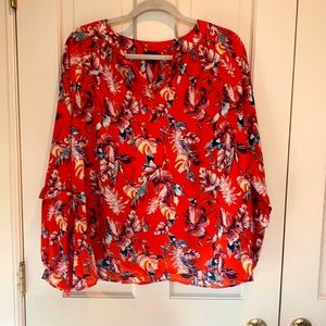 Adorable Blouse with ruffle detail on the sleeve.